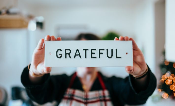 a person holding a white grateful plate