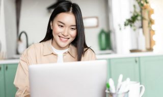 smiling-asian-girl-using-laptop