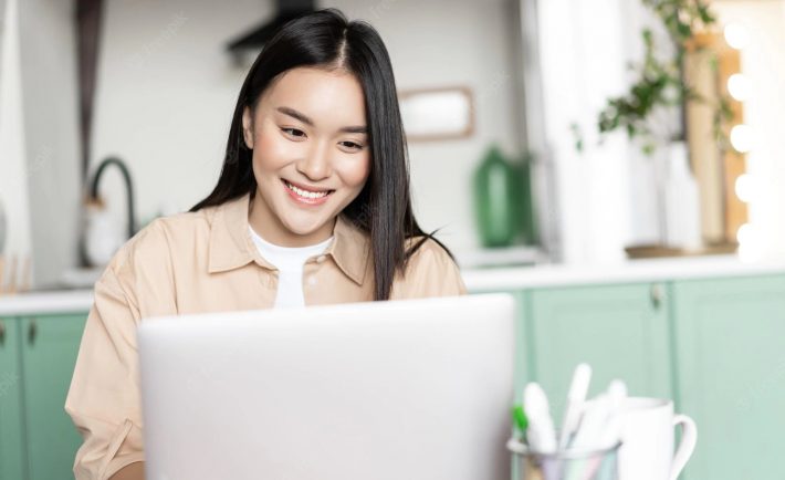 smiling-asian-girl-using-laptop