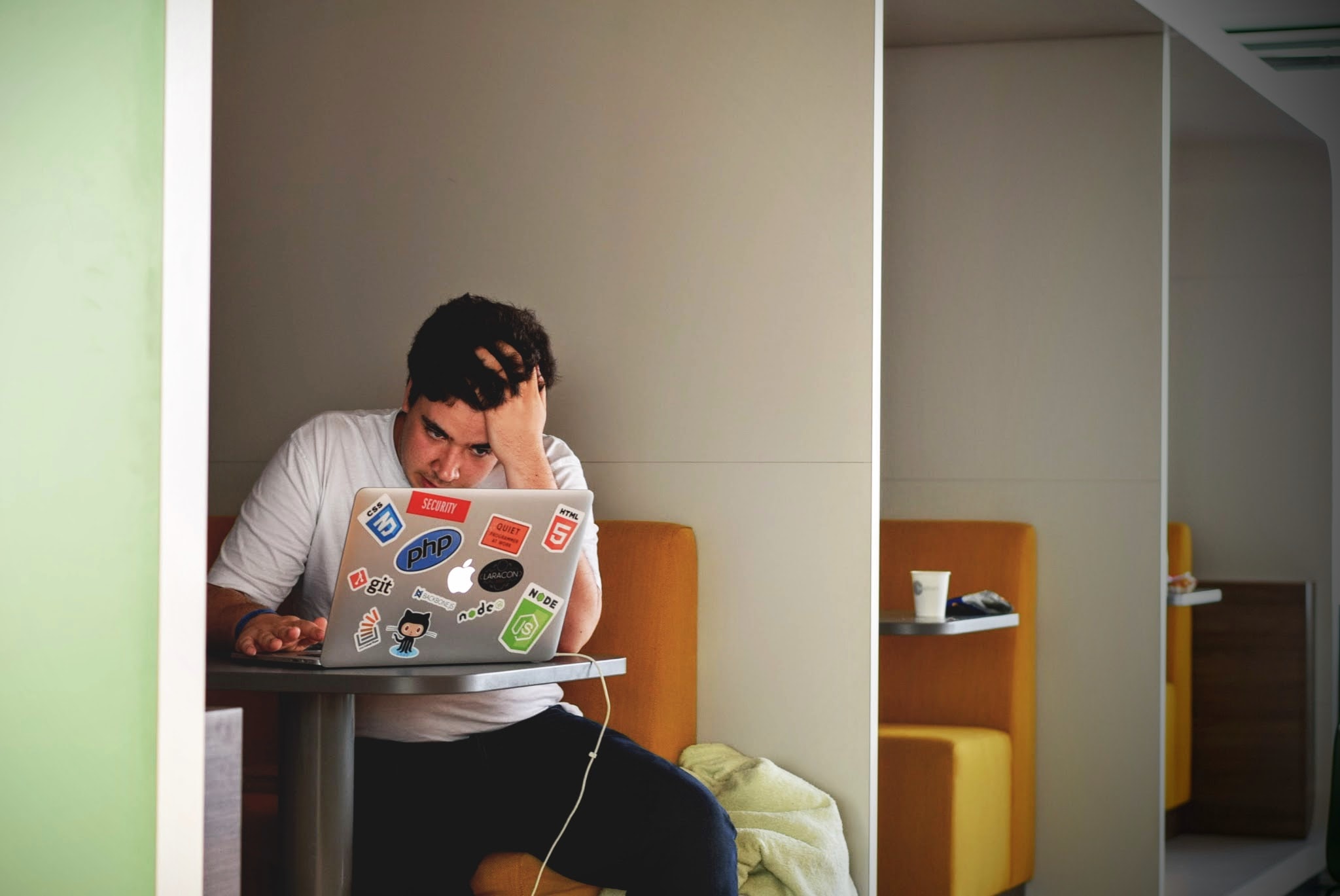 a frustrated man staring at his laptop