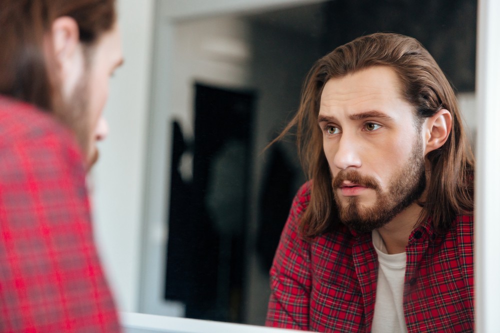 a man looking into the mirror