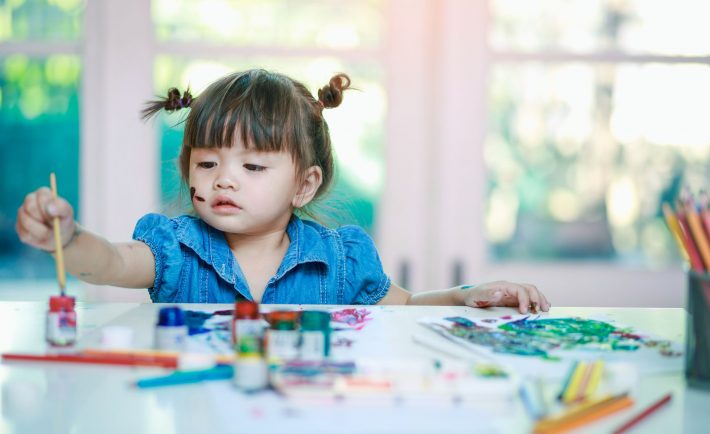 a toddler painting