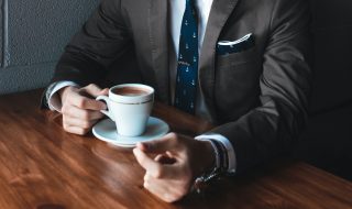 a man taking a break from work drinking coffee