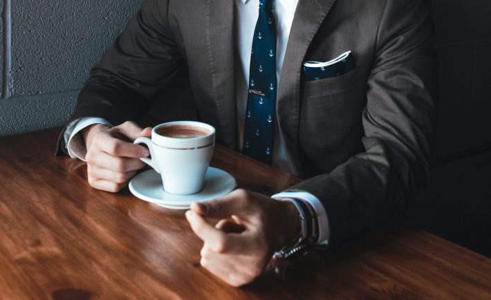 a man taking a break from work drinking coffee