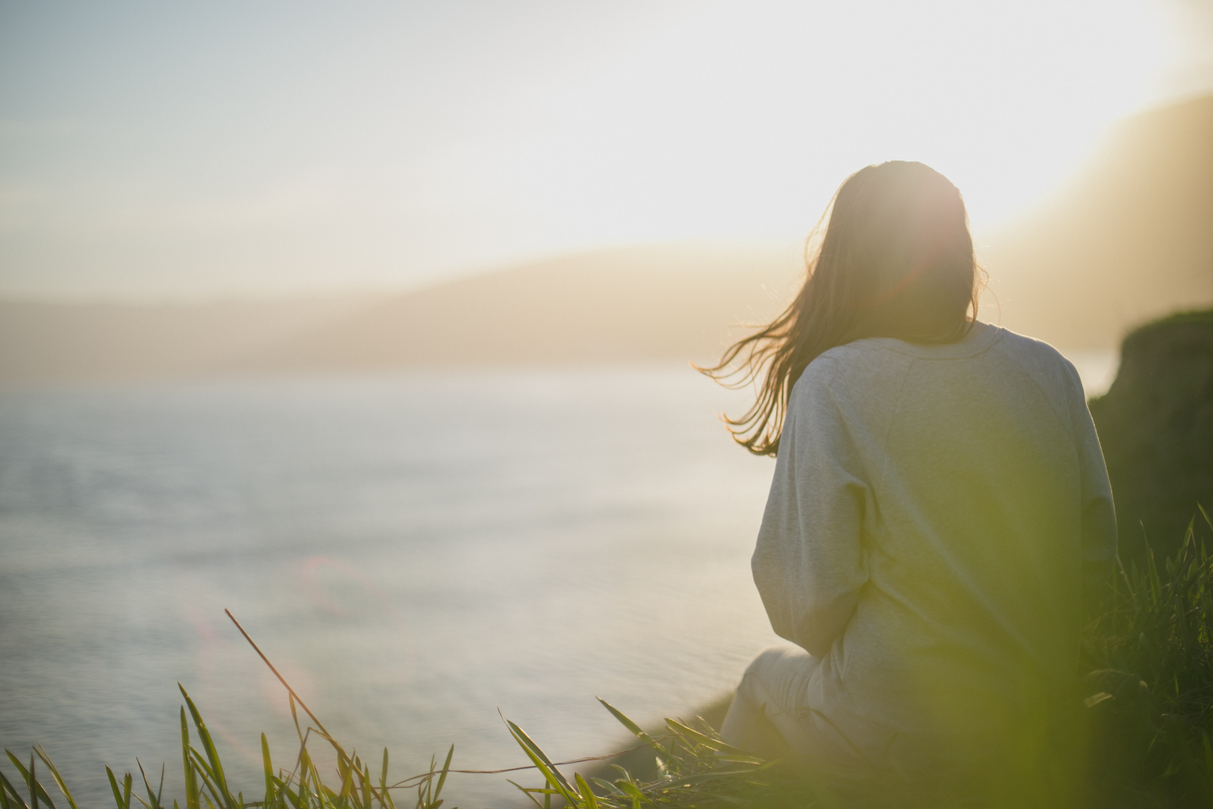 a woman facing the sea