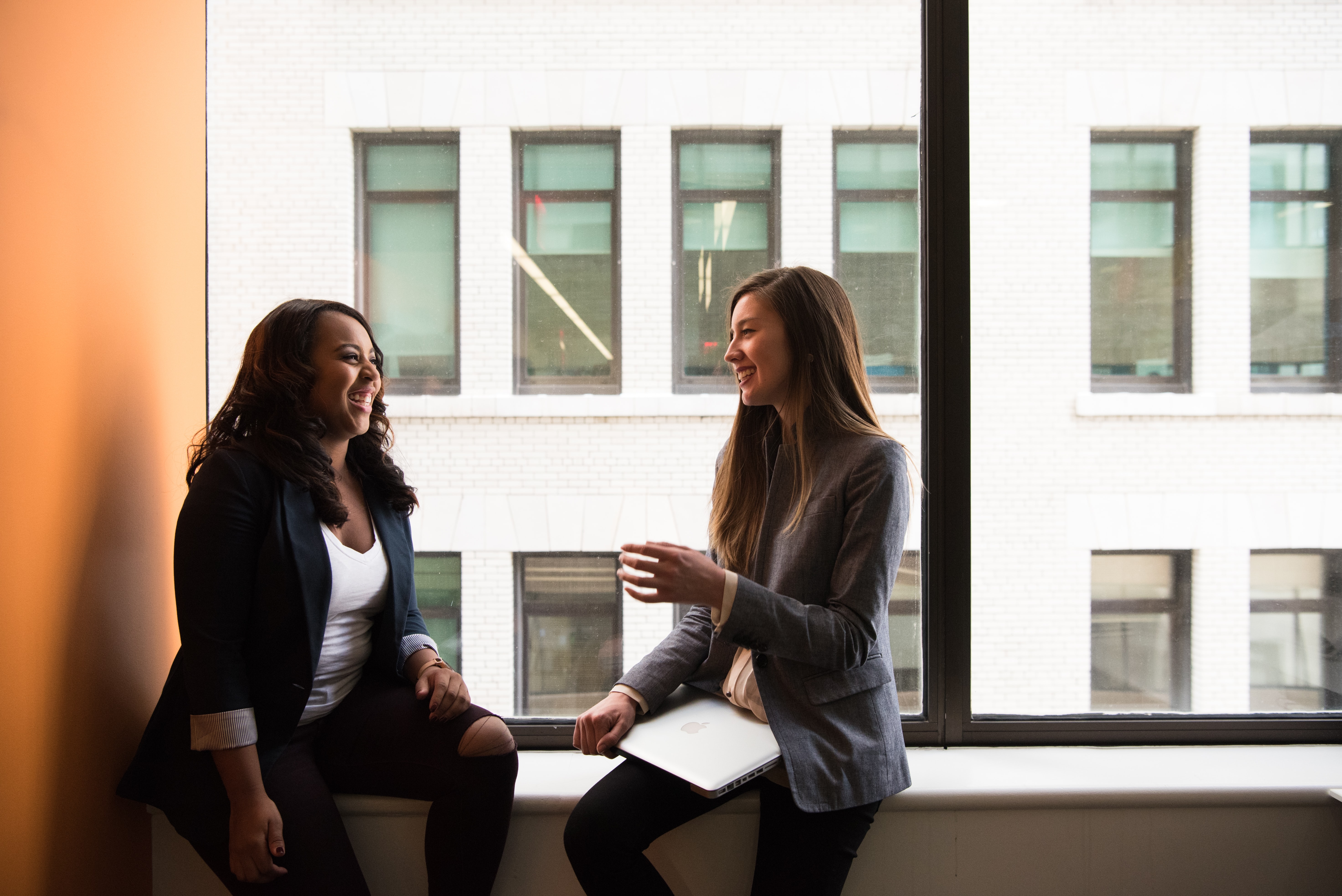 colleagues conversing by the window