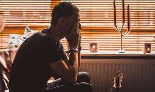 a stressed man sitting on a couch