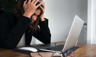 stressed woman in front of her laptop