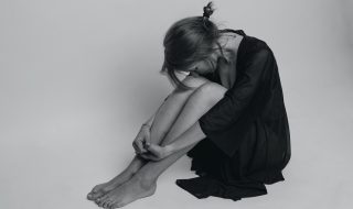 a depressed woman in black dress