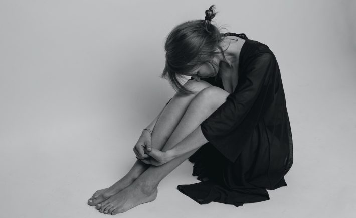 a depressed woman in black dress