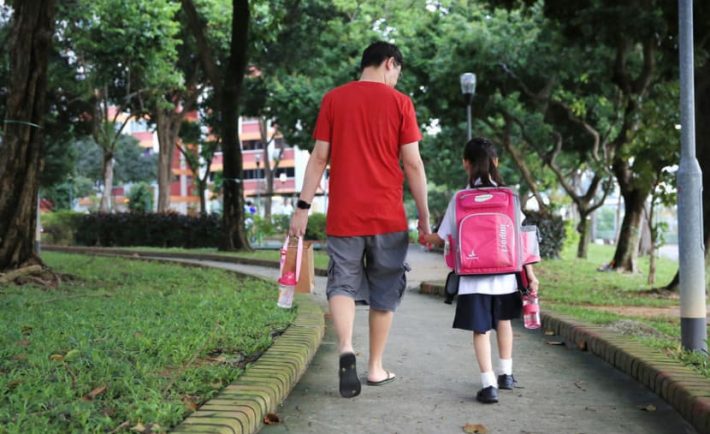 a father and daughter on the way to school