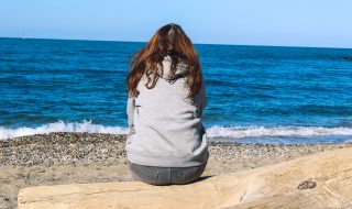 sitting alone by the beach