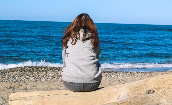 sitting alone by the beach