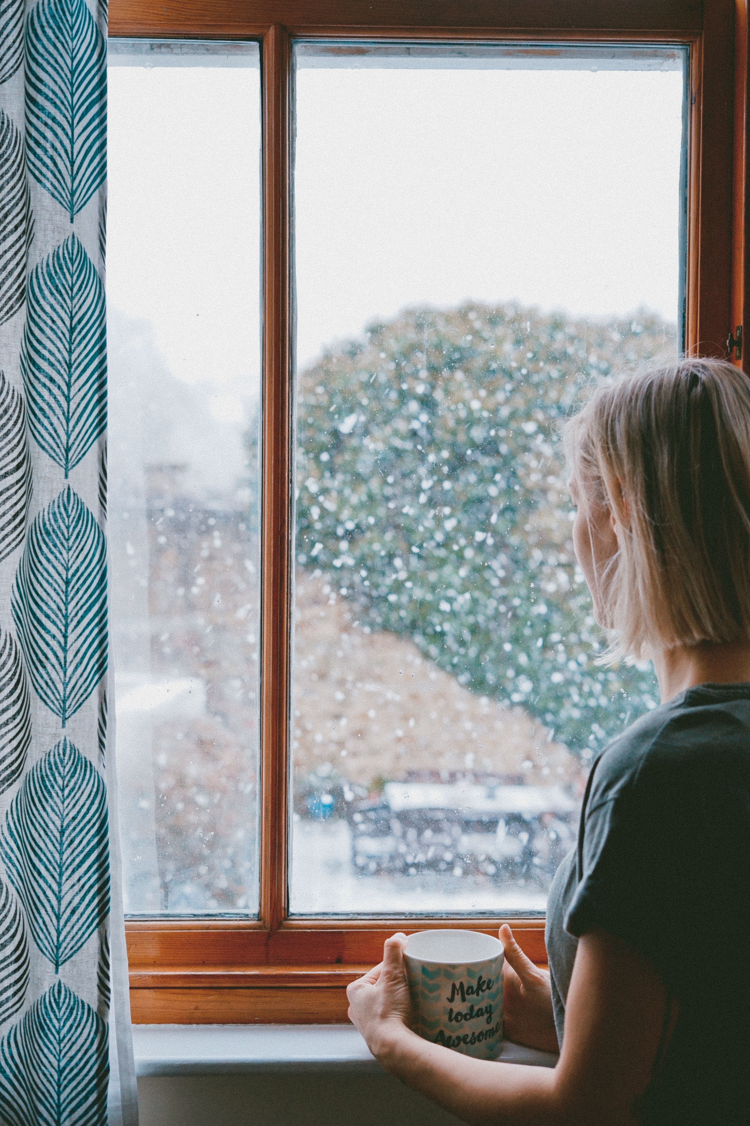 a woman staring out of the window