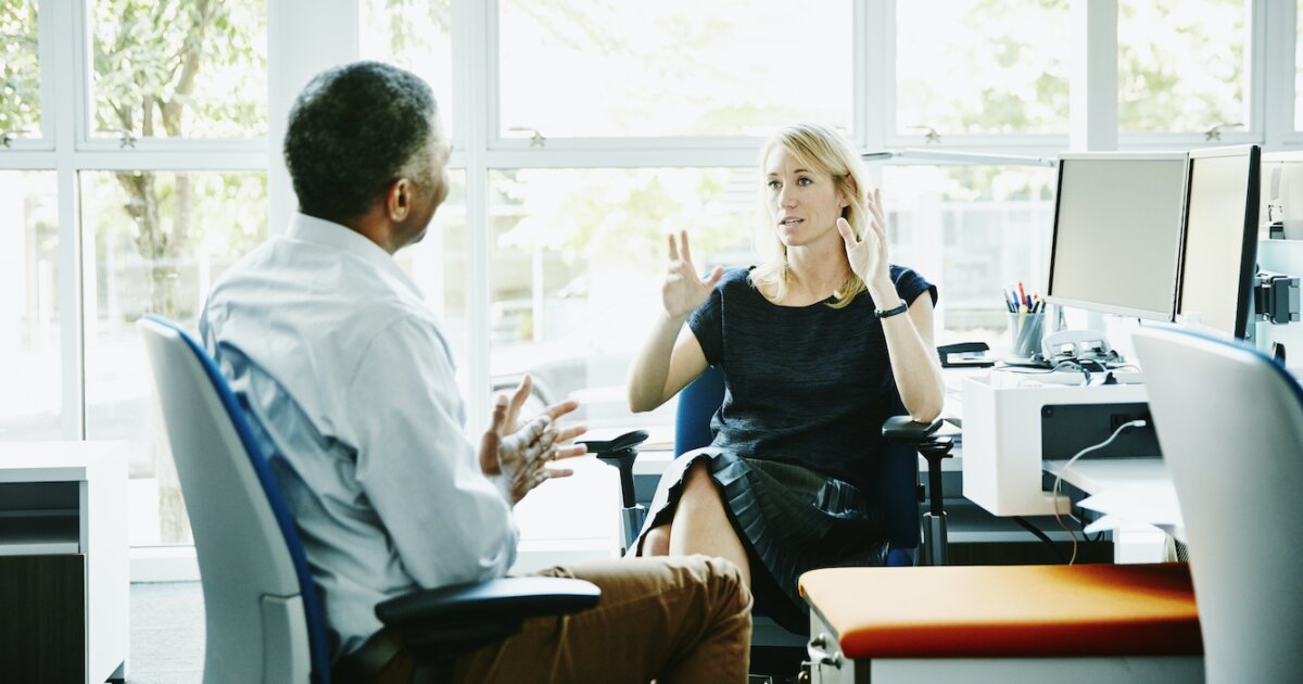 two coworkers in a serious discussion