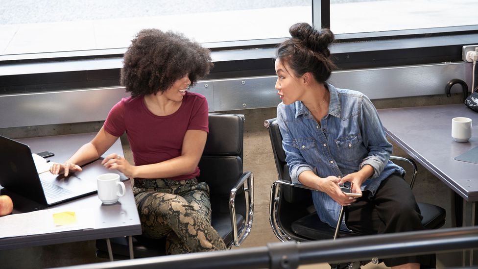 two female colleagues conversing