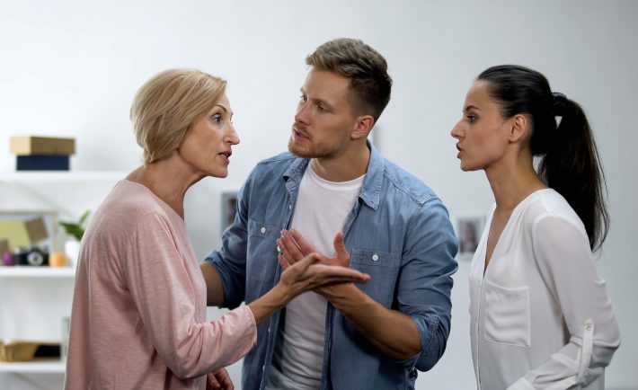 a young man settling conflict between mother and wife