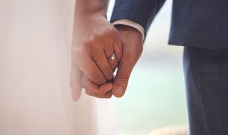 bride and groom holding hands