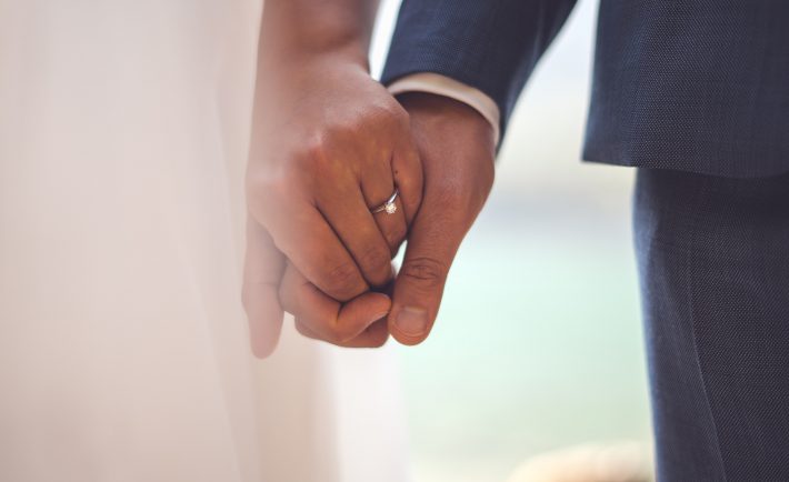 bride and groom holding hands