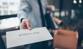 a man holding a resignation letter