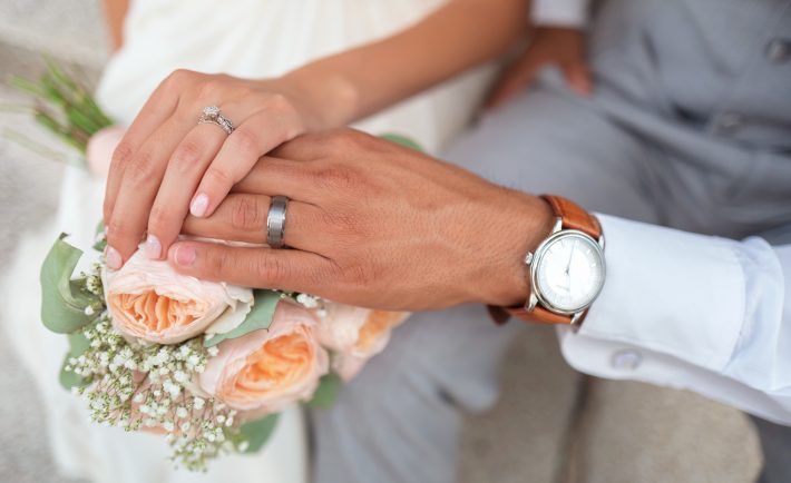 a couple's wedding rings