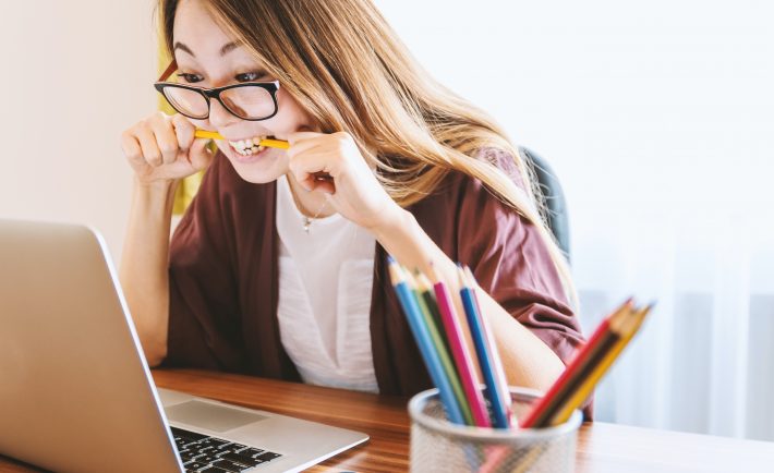 stressed woman biting a pencil