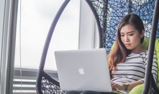 lady using her MacBook at home