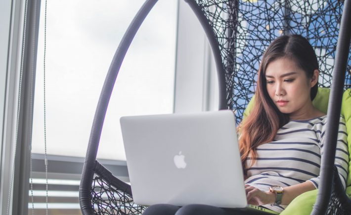 lady using her MacBook at home