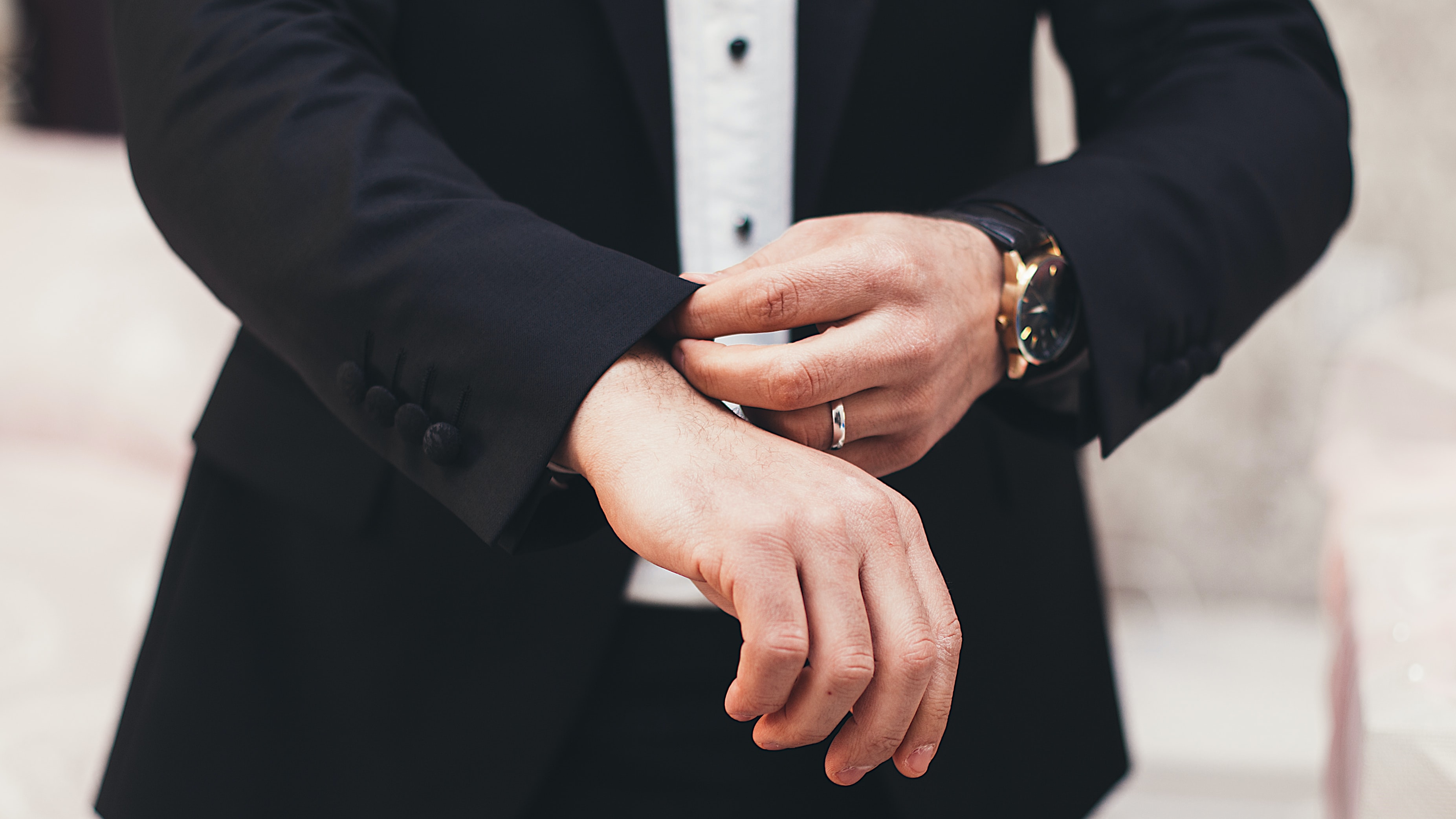 man adjusting his suit