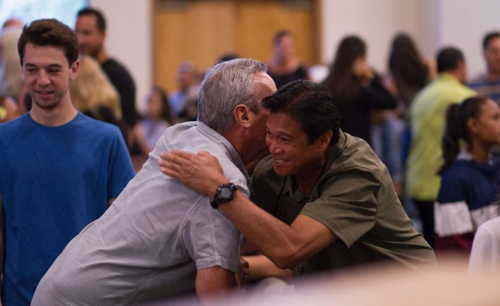 two men greeting each other