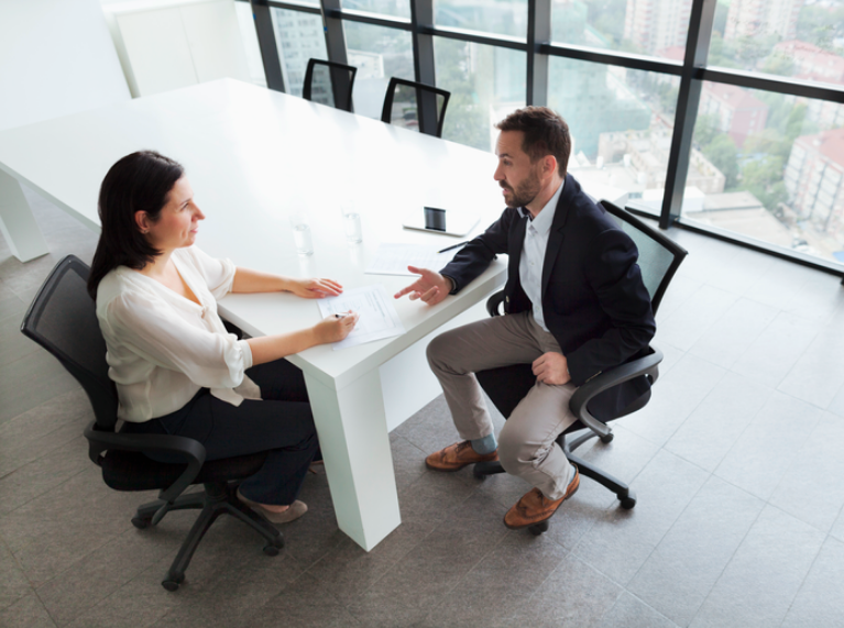 colleagues talking in a meeting room