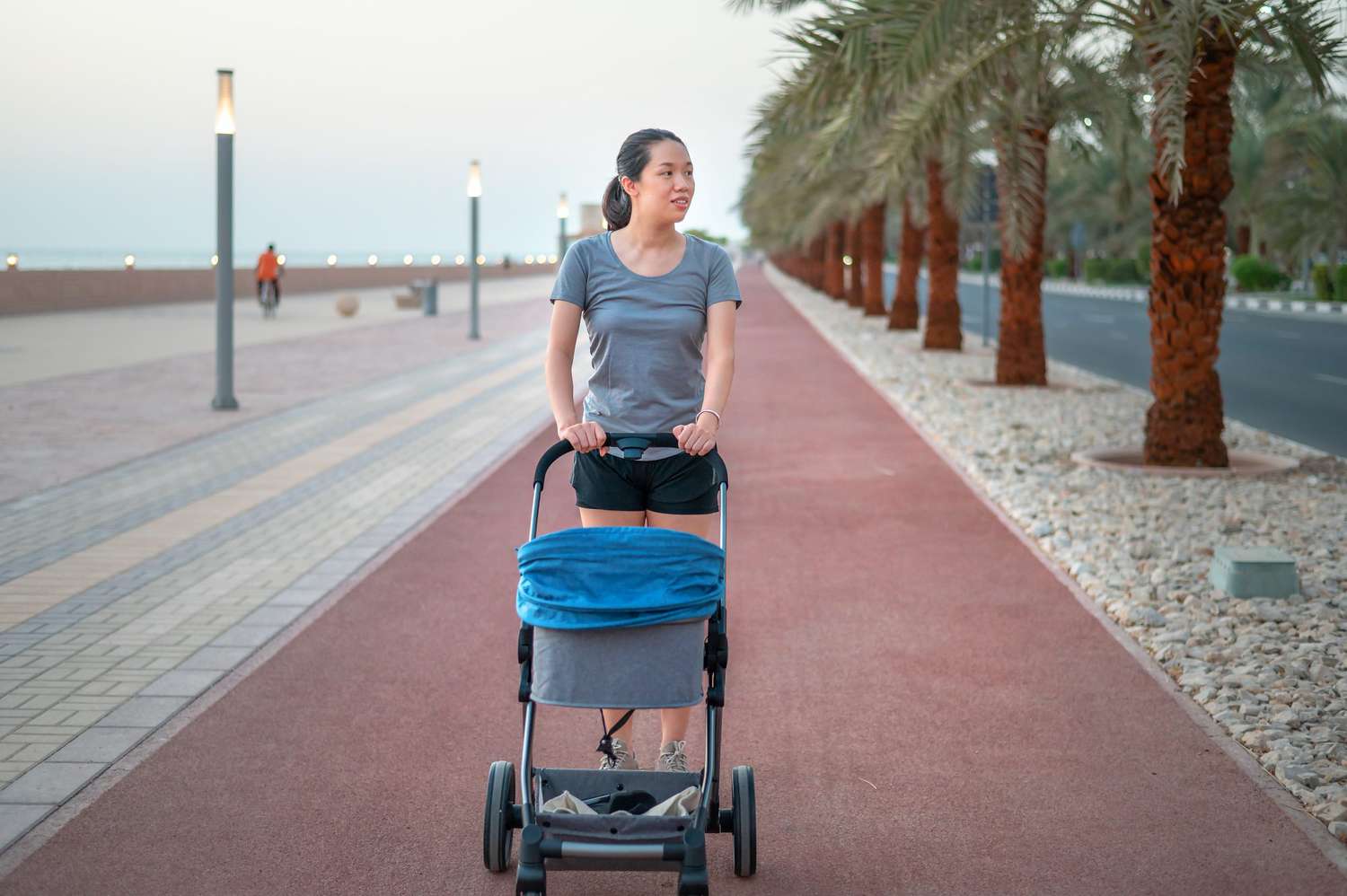 female walking while pushing a pram