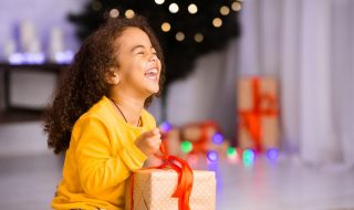 kid delighted with a Christmas gift