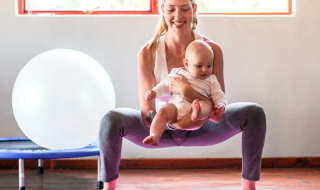 mother doing postnatal yoga with baby