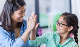 praising a child with a hi-five