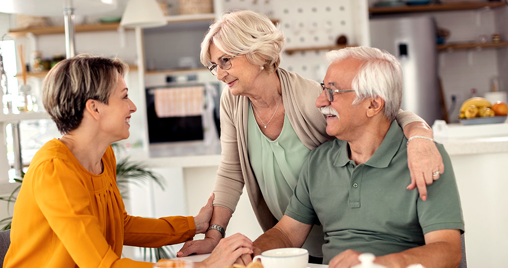 woman talking to elderly parents