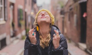 smiling woman keeping her fingers crossed