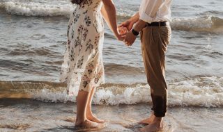 couple holding hands at the beach