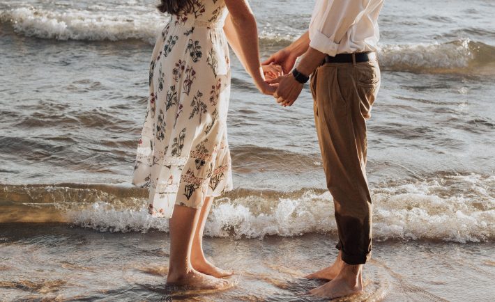 couple holding hands at the beach