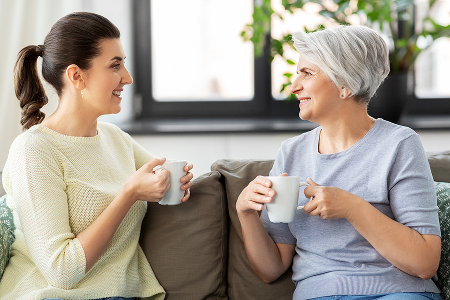 mother and daughter talking over a cup of coffee