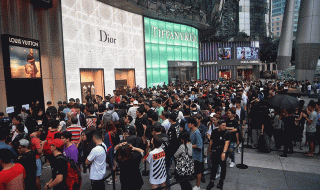 Singaporeans queuing outdoors