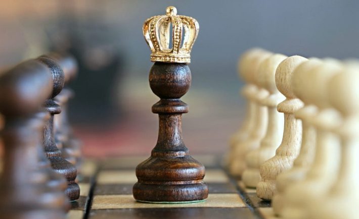 a chess piece wearing a crown