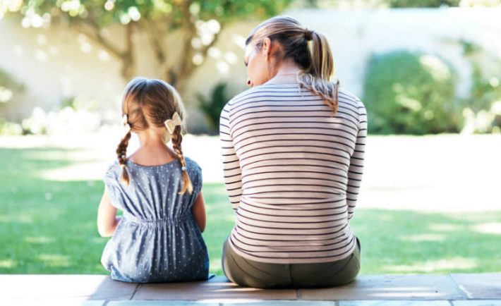 a mum talking to her young daughter