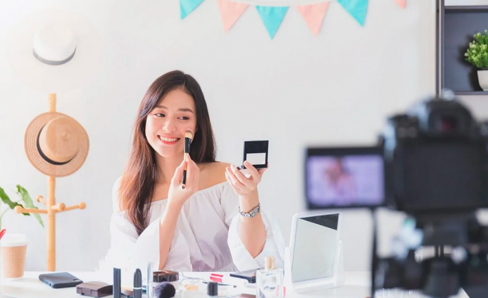 an asian woman creating a make-up video