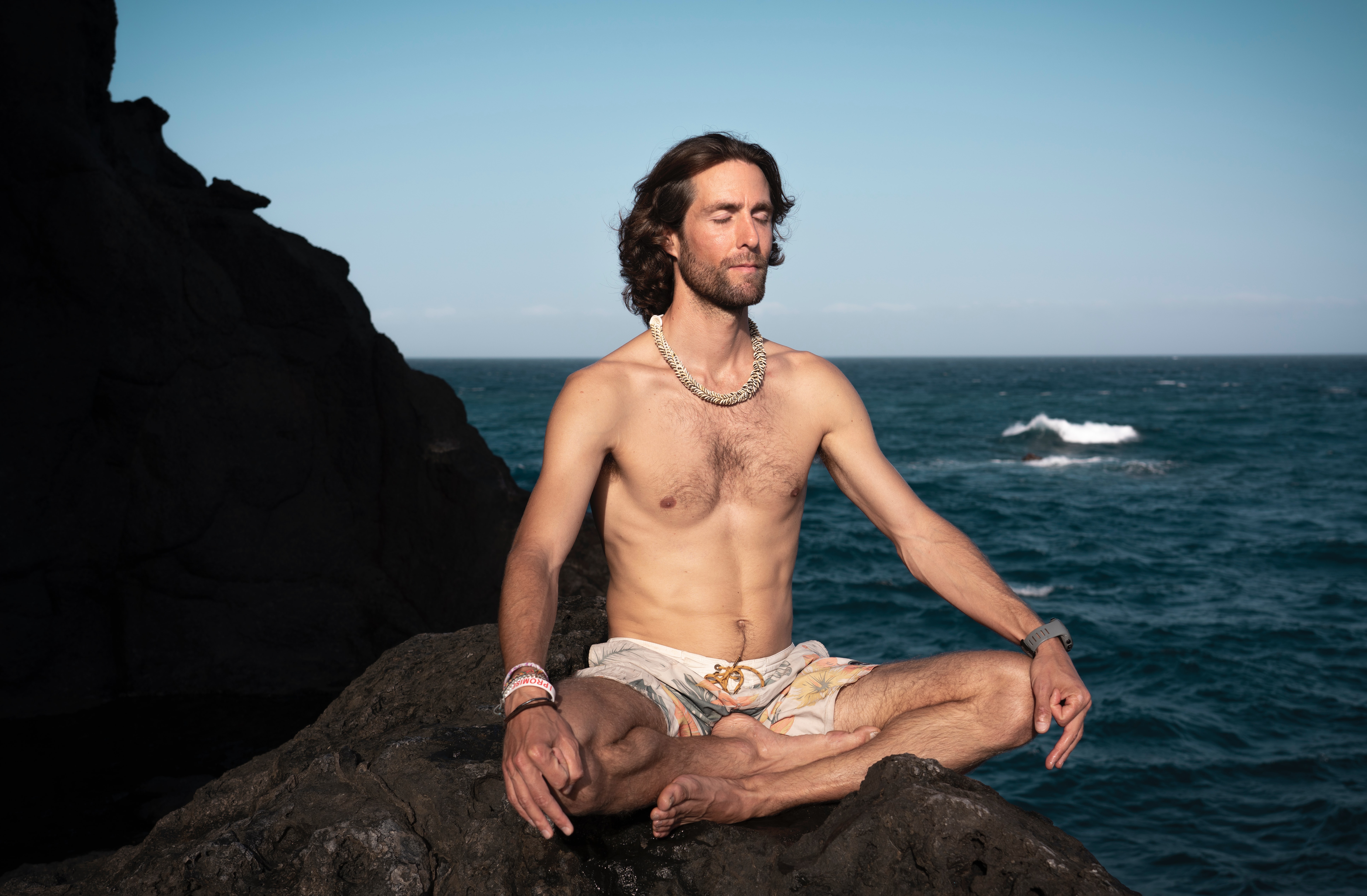 topless man meditating
