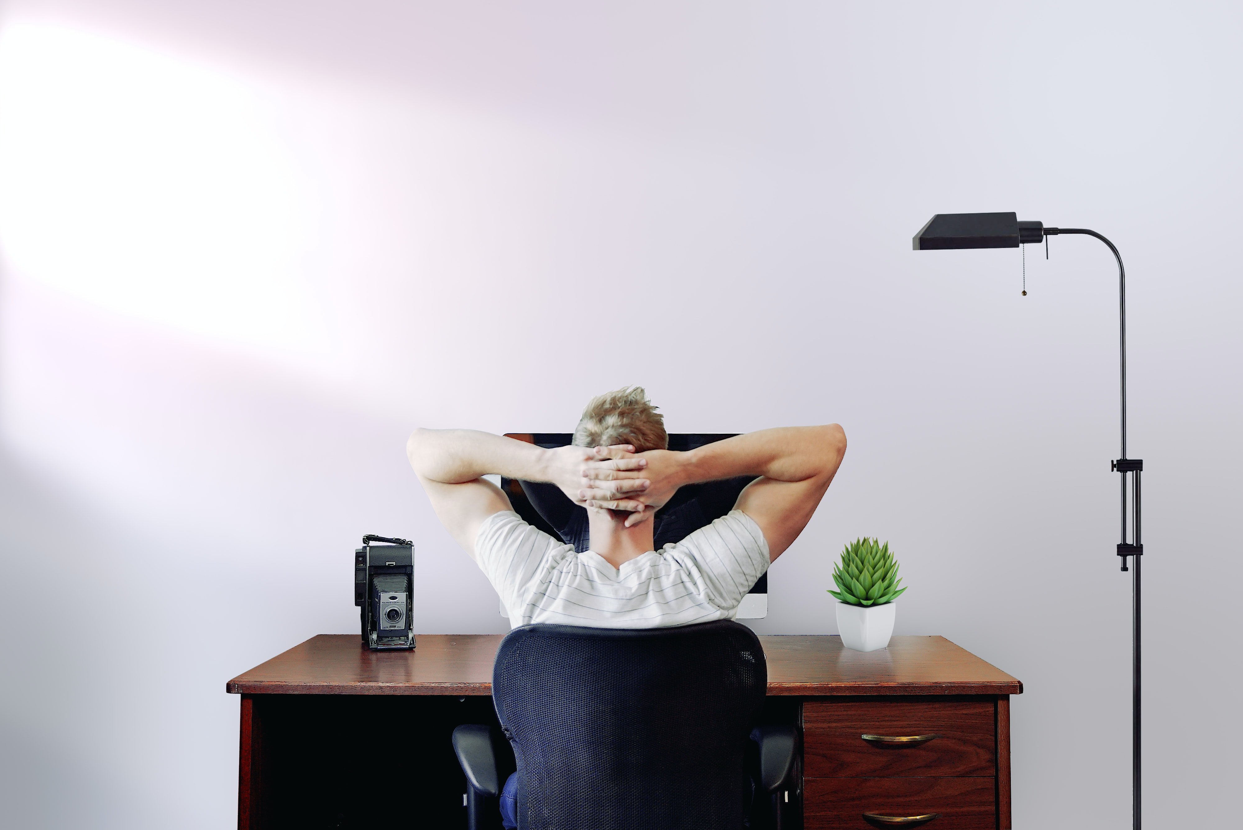 man holding the back of his head with his hands