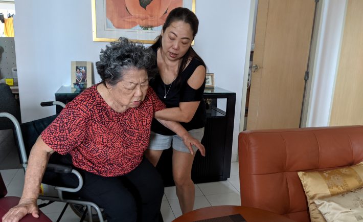 daughter taking care of elderly mom