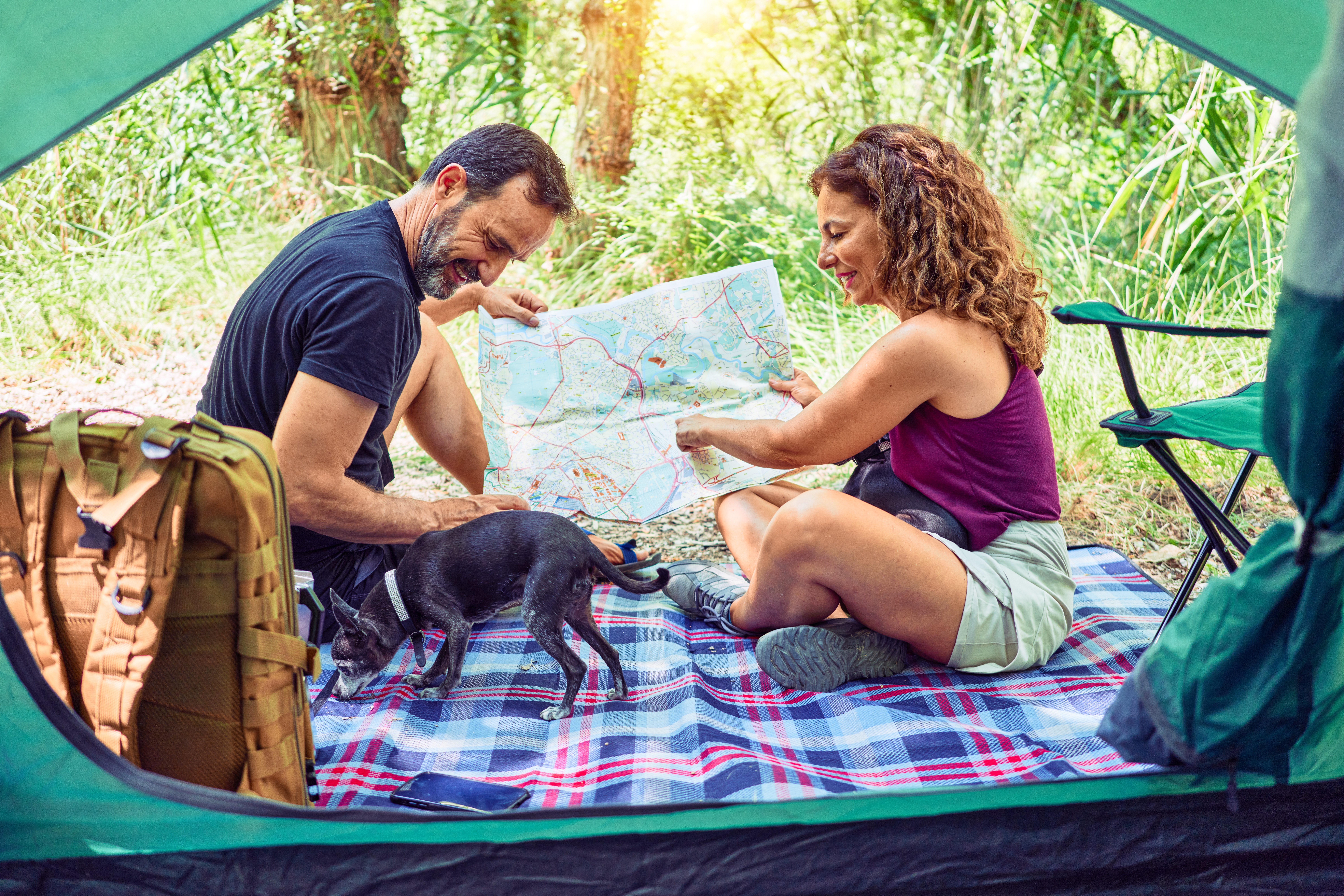 couple camping with their dog