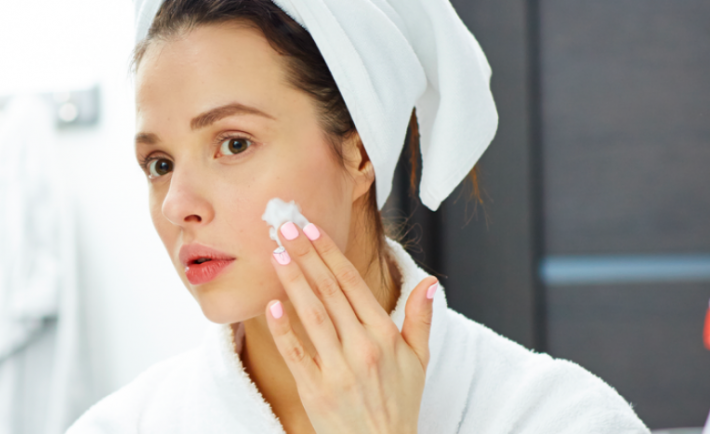 woman applying a face mask