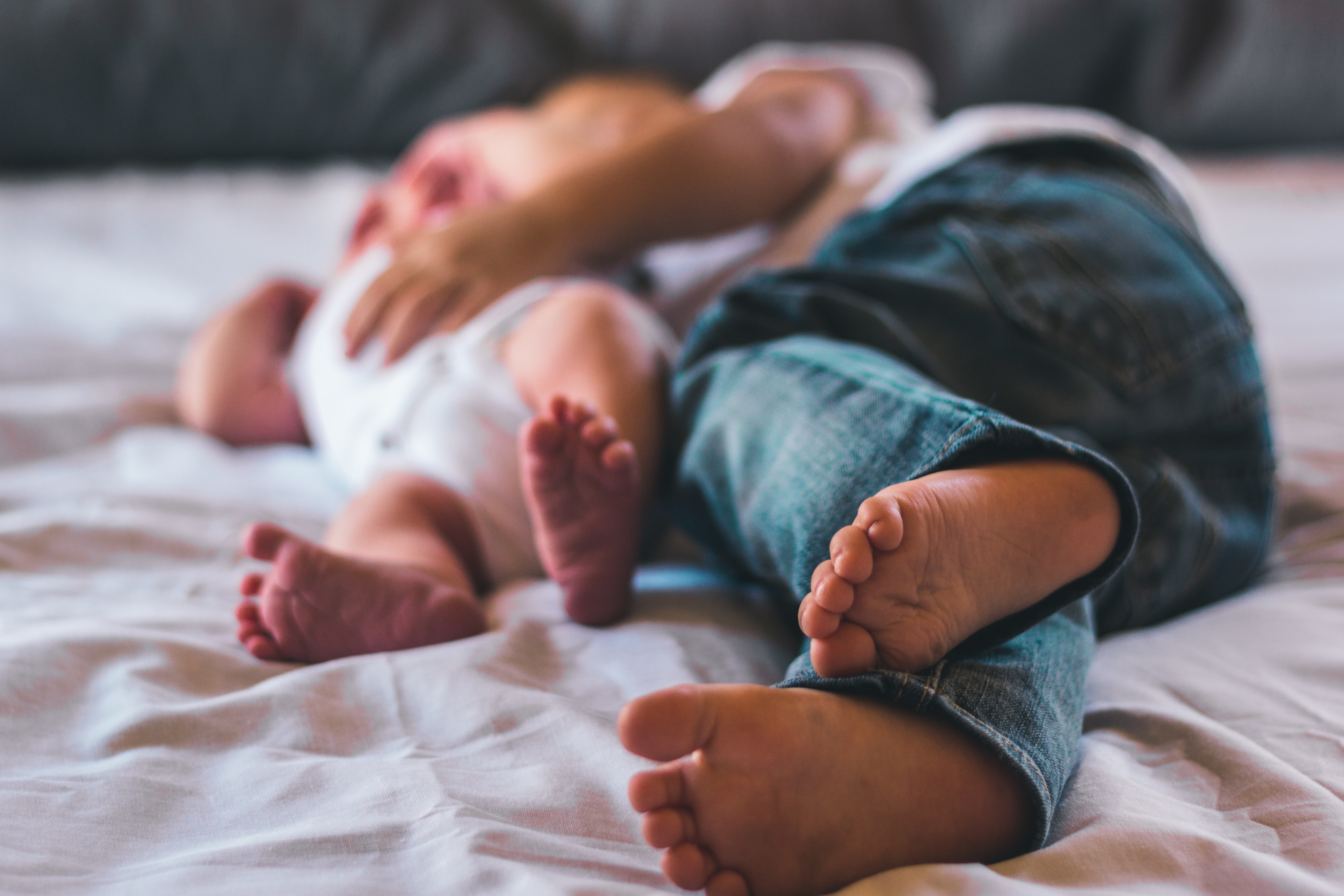 a person lying down with a baby